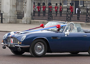 Prince William took his new wife Kate Middleton for a drive around The Mall in his dad's Aston Martin  with the number plate 'Just Wed'.